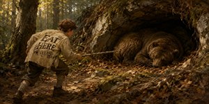 A mischievous boy in weathered nineteenth-century clothing creeps through a sunlit forest, extending a long stick toward a massive sleeping bear curled inside a shallow rocky cave. The bold EAT HERE message across his back adds dark humor, while moss, roots, leaves, and golden light create rich painterly tension throughout.